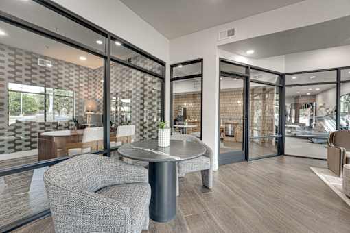 Modern clubhouse lounge with glass walls at The Montrose Apartments, Dallas, TX