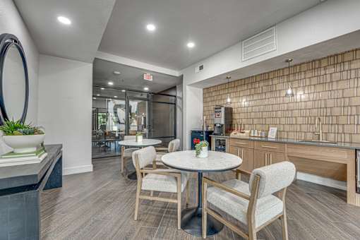 Community cafe with seating and kitchenette at The Montrose Apartments, Dallas