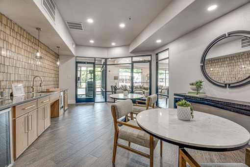 Clubhouse kitchen with dining area and lounge access at The Montrose Apartments, Texas, 75204