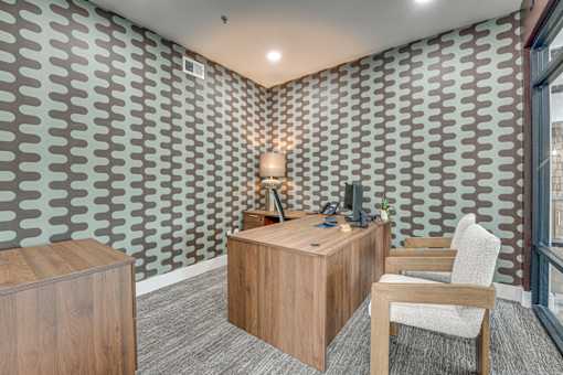 Leasing office desk with patterned accent wall at The Montrose Apartments, Dallas, TX