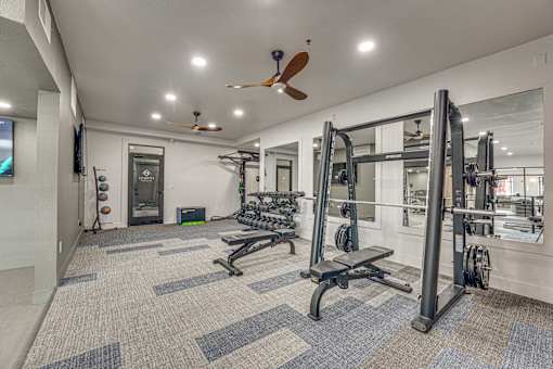 Fitness center with weight training equipment at The Montrose Apartments, Texas