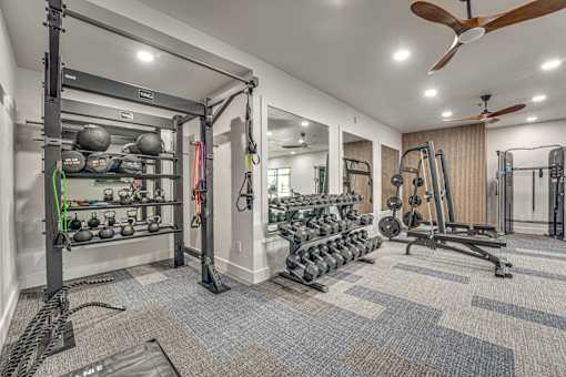 Fully equipped fitness center with free weights at The Montrose Apartments, Texas, 75204
