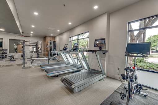 Fitness center with large windows at The Montrose Apartments, Dallas, 75204