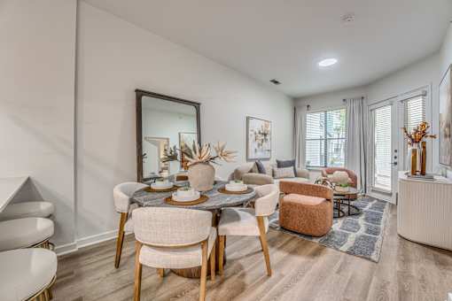 Open concept dining and living room with modern furnishings at The Montrose Apartments, Texas