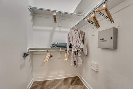 Walk-in closet with hanging rods and shelving at The Montrose Apartments, Dallas, TX