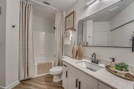 Modern bathroom with white vanity and undermount sink at The Montrose Apartments, Texas