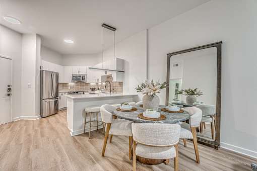 Open concept kitchen and dining area with island seating at The Montrose Apartments, Dallas, 75204