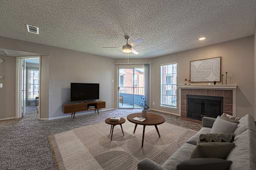 A living room with a fireplace and a television.