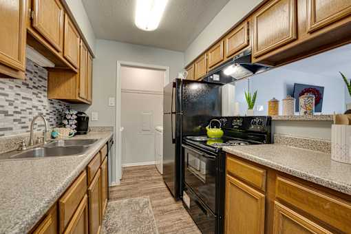 kitchen with black refrigerator at Southern Oaks, Fort Worth  