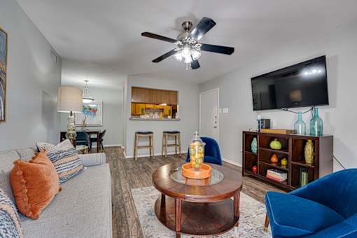 coffee table, and a flat screen TV mounted on the wall at Southern Oaks, Fort Worth, TX