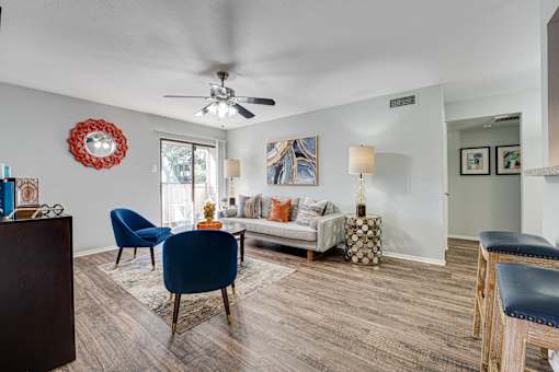 living room with white couch and blue chair at Southern Oaks, Texas
