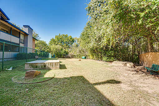 backyard with a wooden deck at Southern Oaks, Fort Worth, TX 76132