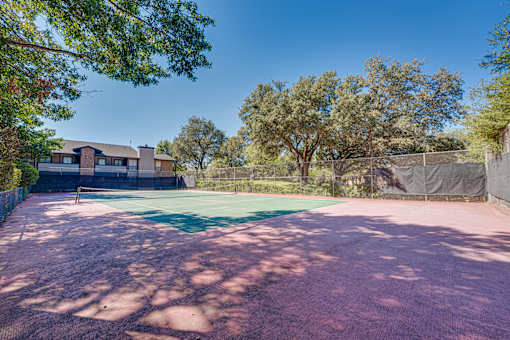tennis court surrounded by trees at Southern Oaks, Fort Worth, TX 76132