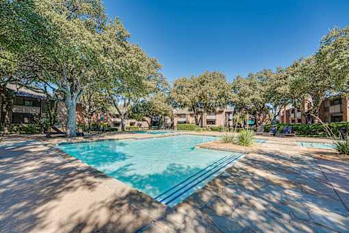 swimming pool surrounded by large trees at Southern Oaks, Texas, 76132