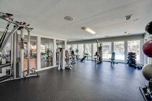spacious gym with a variety of equipment at Southern Oaks, Fort Worth, TX