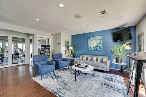 living room with white sofa blue accent wall at Southern Oaks, Fort Worth, TX