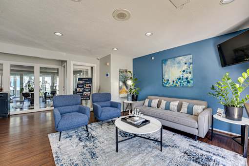 living room with a blue accent wall at Southern Oaks, Texas