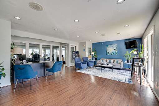 living with blue chairs and a wooden floor. at Southern Oaks, Texas, 76132