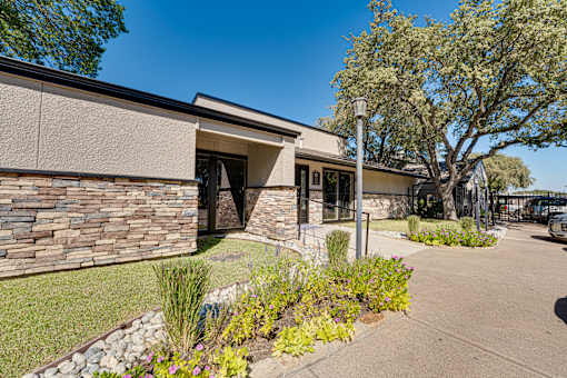 house with a stone wall at Southern Oaks, Fort Worth, 76132