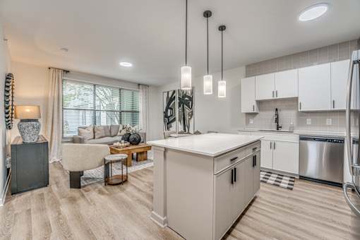 Open concept kitchen and living room with island at The Barton Apartments, Dallas, Texas