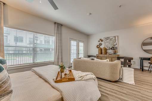 A bedroom with a large bed and a couch.