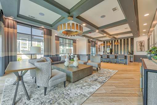 A modern living room with a grey sofa and a wooden coffee table.