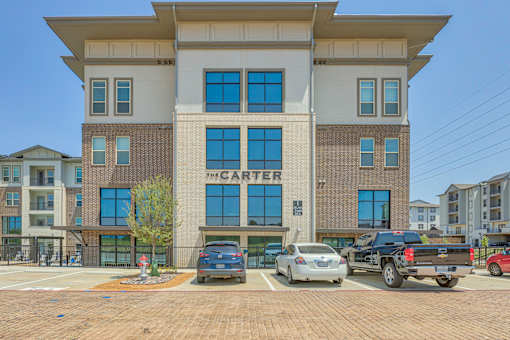 The Carter building has a parking lot in front of it.