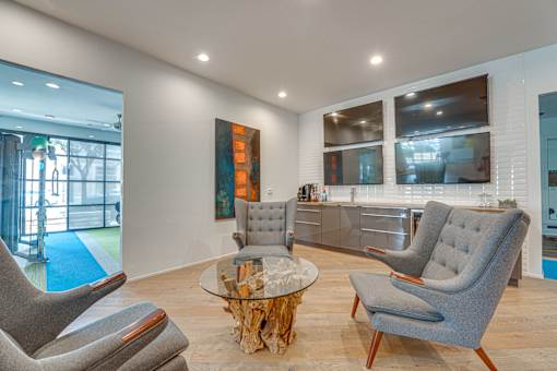 Contemporary lounge with wet bar and seating at Vue Live Oak Apartments, Dallas