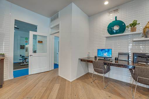 Study area with built in desk and chairs at Vue Live Oak Apartments, Texas