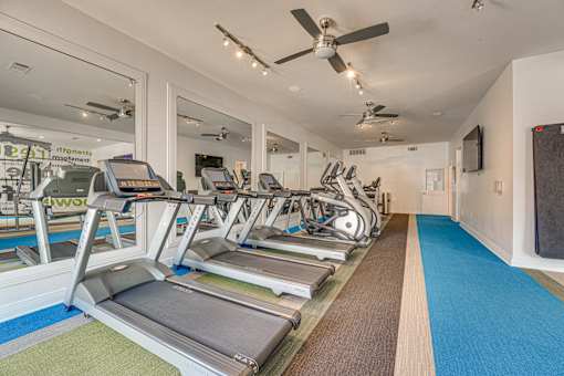 Fitness center with cardio equipment at Vue Live Oak Apartments, Dallas, TX