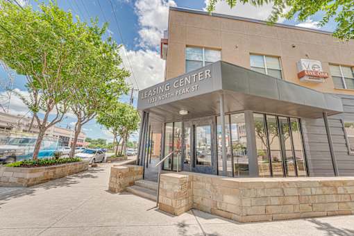 Leasing center entrance with stone base and signage at Vue Live Oak Apartments, Dallas, Texas