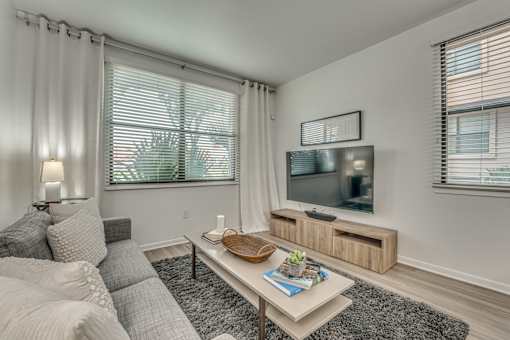 Living room with tv and entertainment center at Vue Live Oak Apartments, Dallas, TX 75204