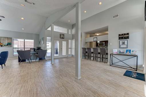 A spacious living room with a dining area and a kitchen in the background. at Wilson Crossing, Cedar Hill, TX
