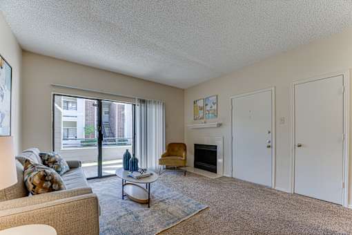 A living room with a couch, chair, and fireplace. at Wilson Crossing, Cedar Hill, TX