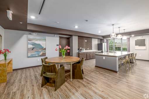 A dining room with a wooden table and chairs.