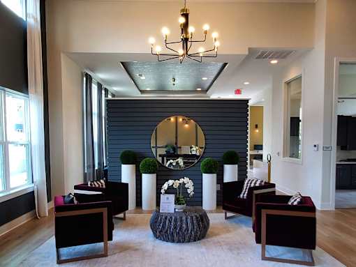 A large mirror hangs on a wall above a table with chairs around it.