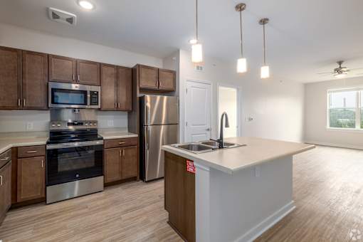 A kitchen with wooden cabinets and stainless steel appliances.
