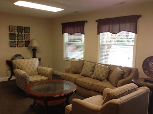 A living room with a couch, chair, and table.