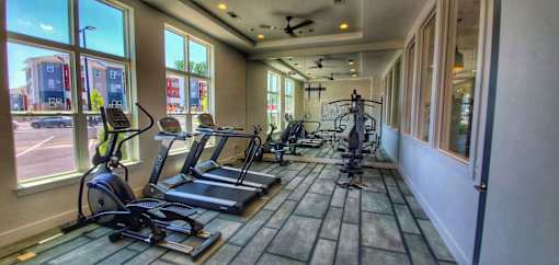 A gym with treadmills and exercise bikes.