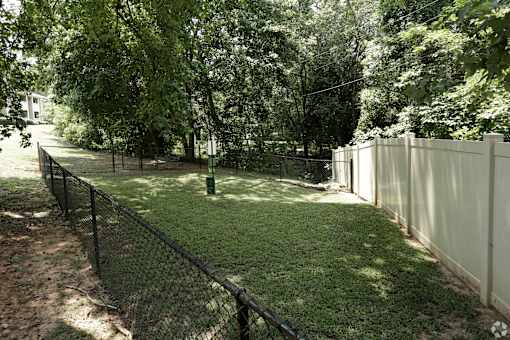 A white fence borders a green lawn.