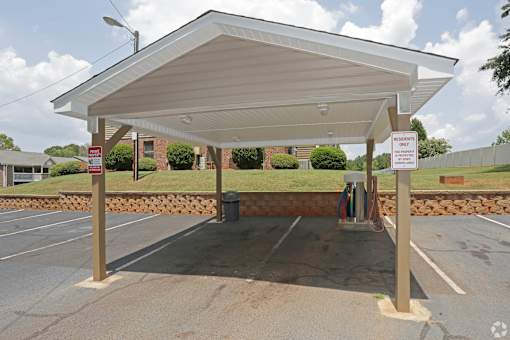 A gas station with a sign that says "NO PARKING ANY TIME".