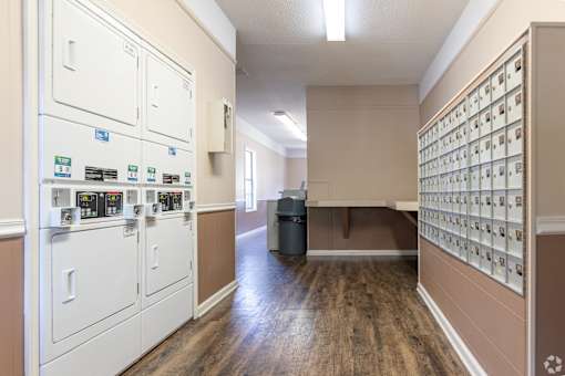 A long hallway with a wall of mailboxes on the right.