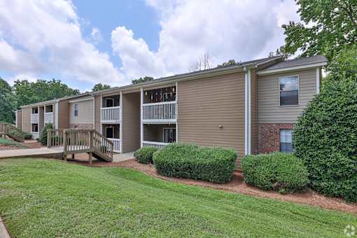 Apartment complex with a green lawn in front.