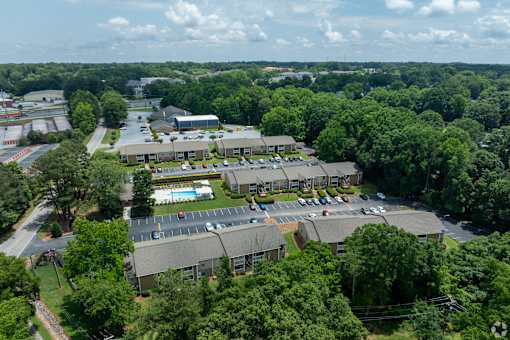 A large building complex surrounded by trees.