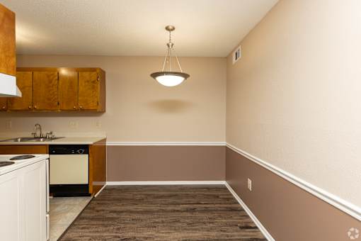 A kitchen with a white dishwasher and a white oven.