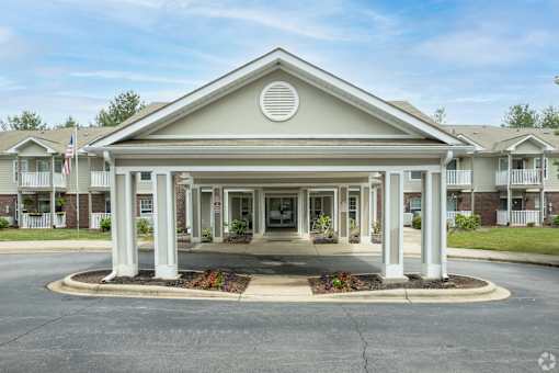A building with a white entrance and pillars.