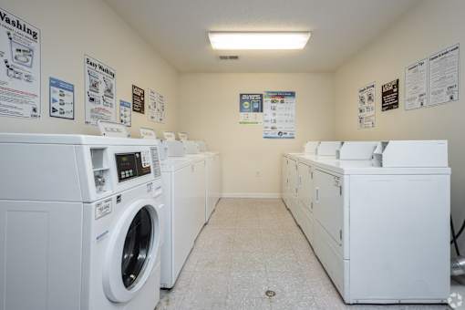 A laundry room with washers and dryers.