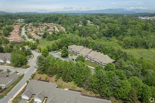 A bird's eye view of a residential area with houses and trees.