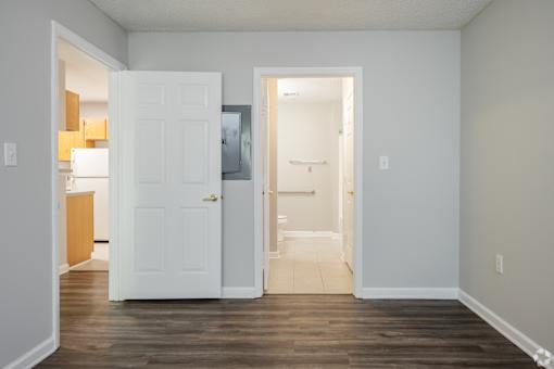 A white door is open to a hallway.