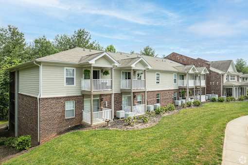 A row of houses with a grassy front yard.